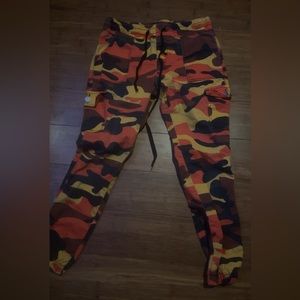 red, orange, black and brown camouflage jeans